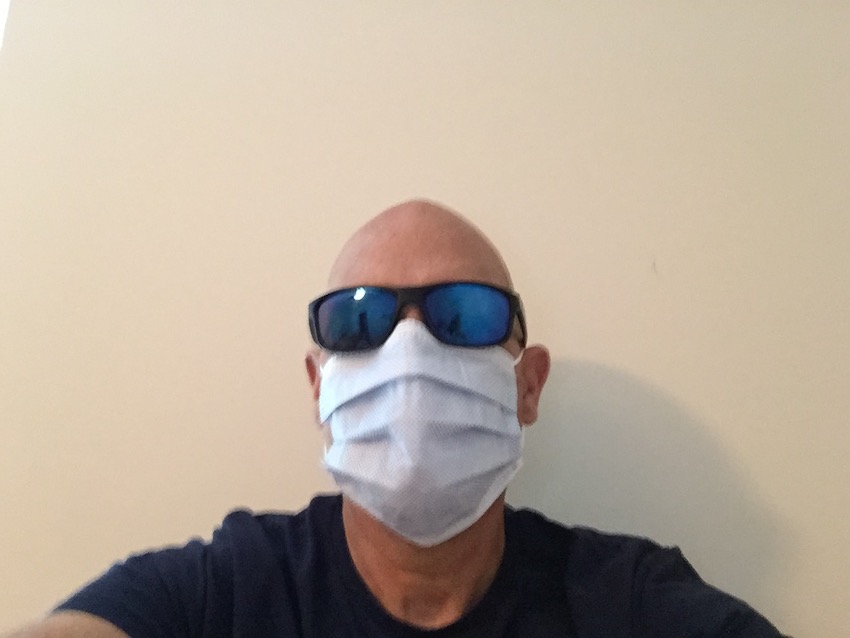 Mike wearing a white medical mask and sunglasses