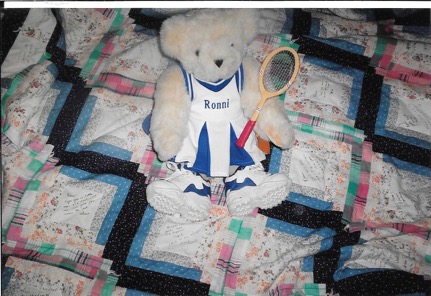 Stuffed animal bear in a tennis outfit