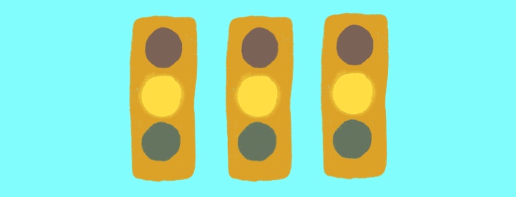 three yellow stop lights