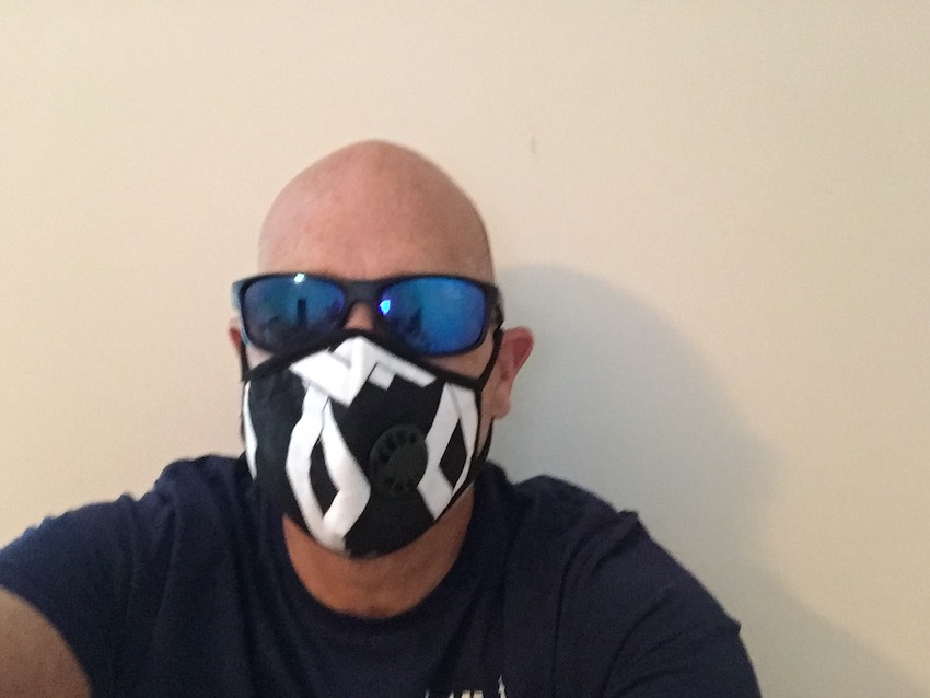 Mike wearing black and white mask with sunglasses
