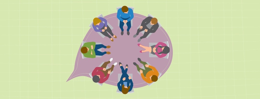 group of people sitting in a circle talking