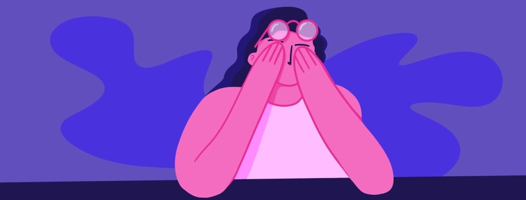 an exhausted woman rubbing her eyes, and looking stressed