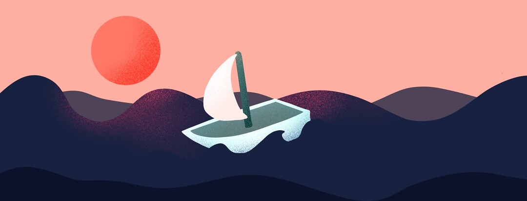 A sailboat on a choppy ocean at sunset