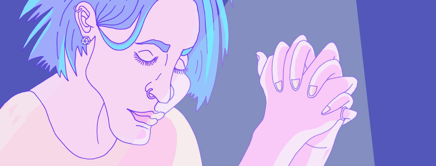 A woman with her hands clasped in prayer