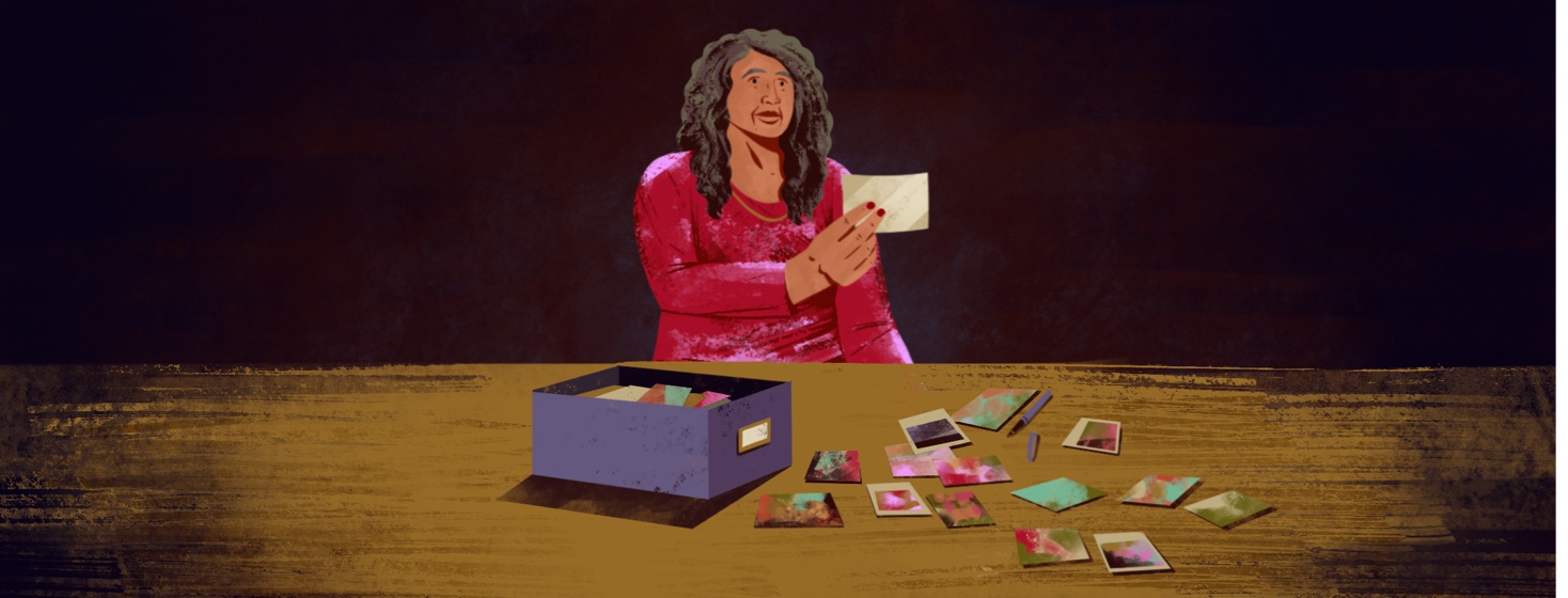 A woman looks through a box of old photos