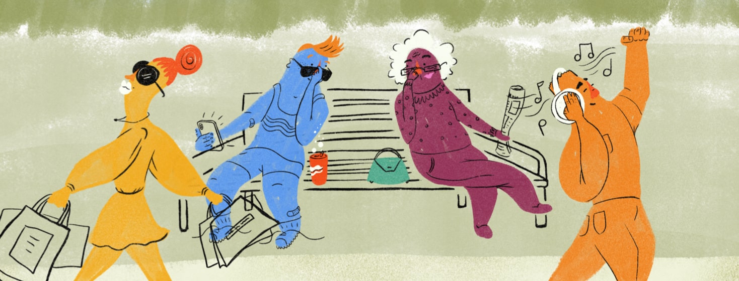 Two people sitting on a park bench looking at each other under their sunglasses