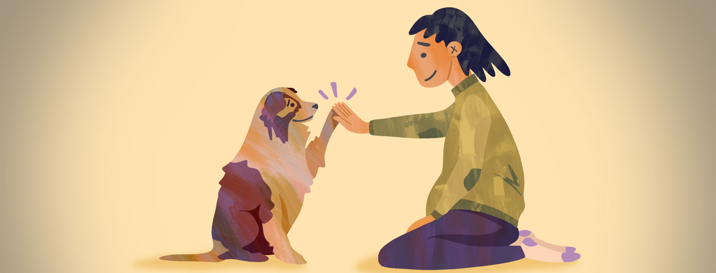 A woman kneels down and gives her cute dog a high five