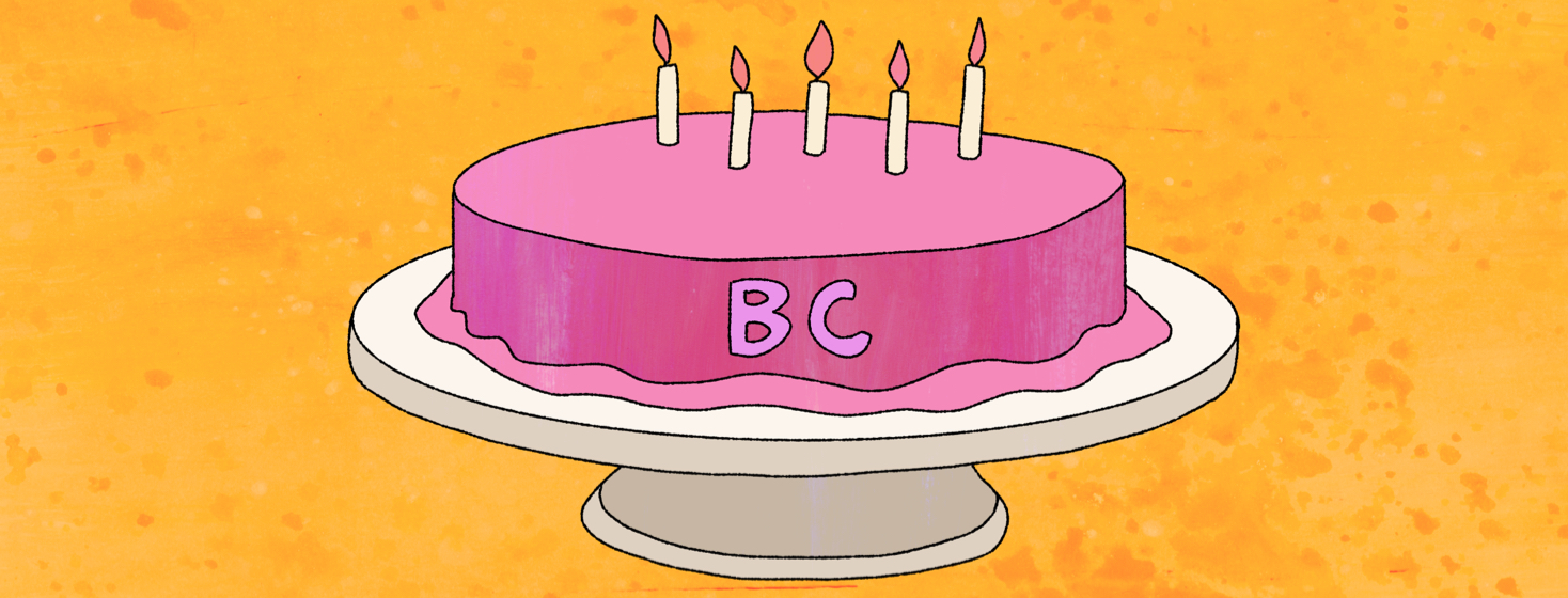 A birthday cake with five candles and the letters "BC" on it